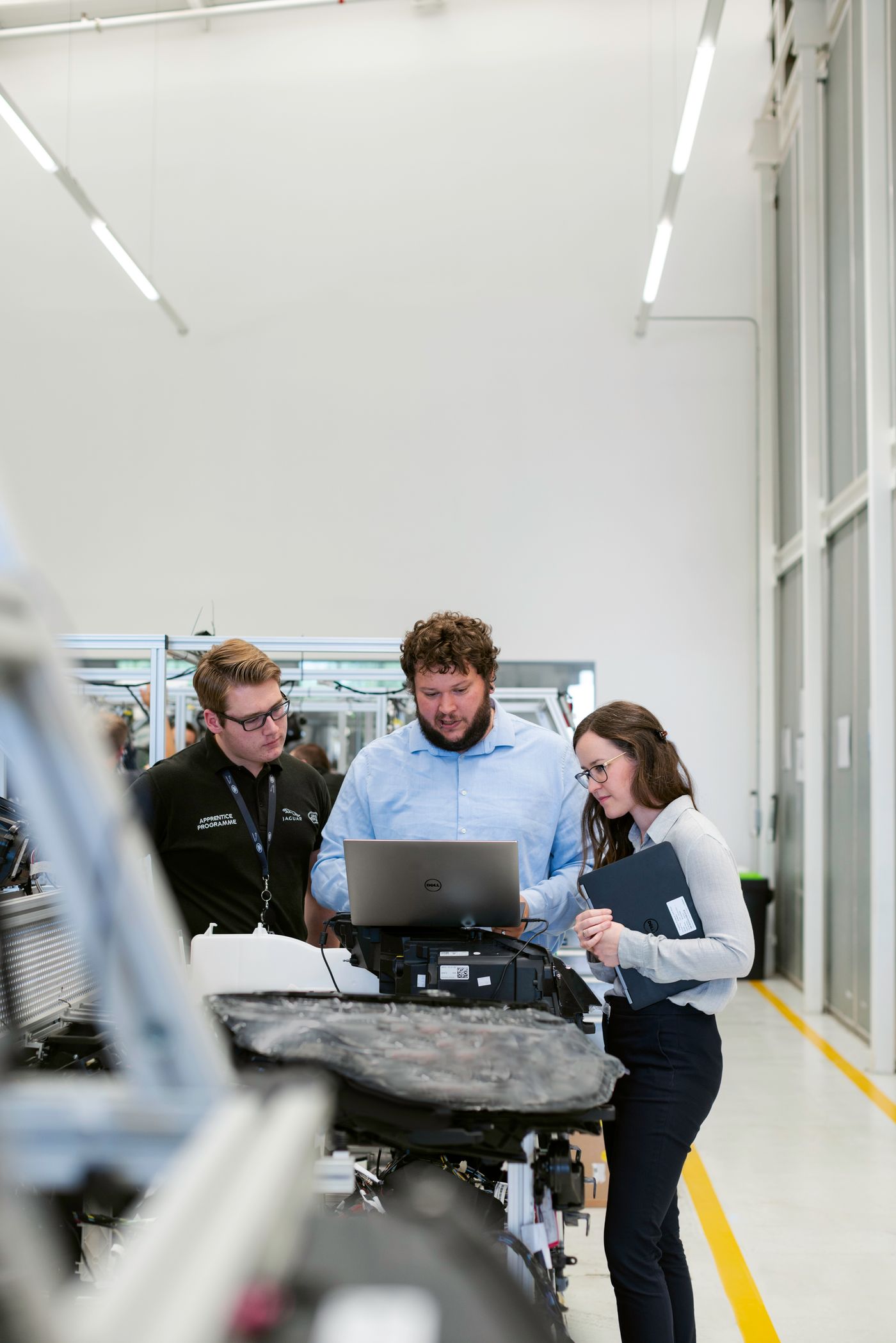 Engineers discussing equipment requirements in a workshop
